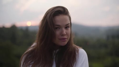 Portrait of Smiling Woman in Nature at Sunrise