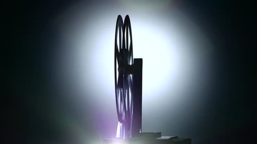 Closeup. Silhouette the Film Roll Rotation Retro Cinema Projector