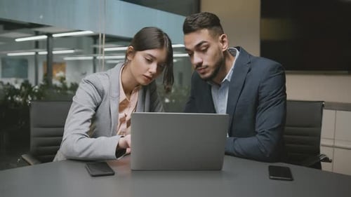 Business Colleagues Working Together on Laptop in Office