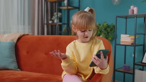 Cute Girl Video Calling with Mobile Phone at Home