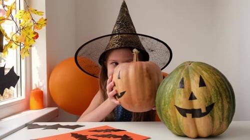 Smiling Happy Little Girl in Witch Costume Preparing for Halloween Party at Home