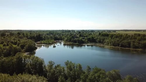 Lake Surrounded by Lush Green Trees Aerial Shot