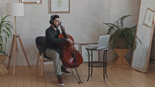 Young Adult Plays Cello at Home