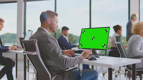 Office Workers at Desks with Chroma Key Screen
