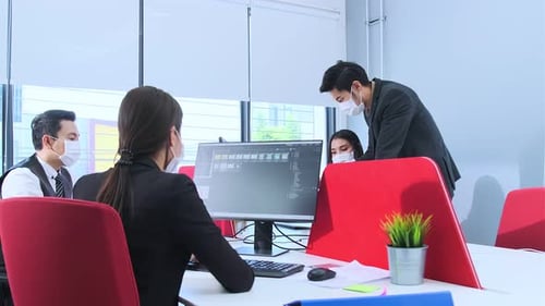 Businesspeople with face masks in the office during COVID-19 pandemic