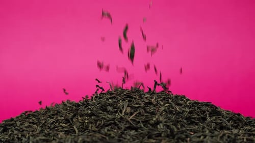 Tea Leaves Falling on Pile of Tea Leaves