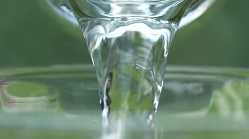 Pouring Clear Liquid in Macro Shot