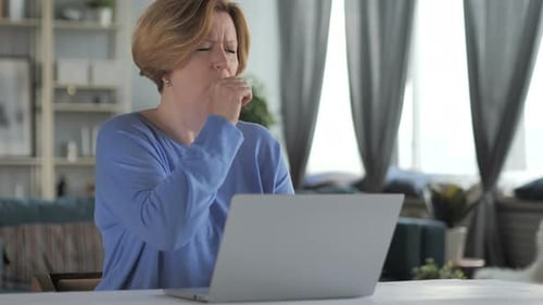 Woman Coughing While Using Laptop at Home