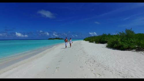 Man and woman sunbathe on relaxing resort beach adventure by blue lagoon and white sandy background