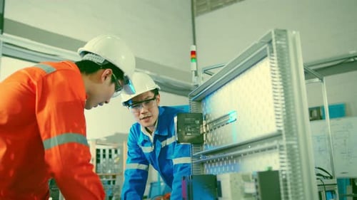 Engineers Working on Electronics in Modern Factory