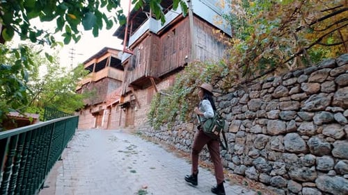 Woman Walking Up Stone Street in Old Town