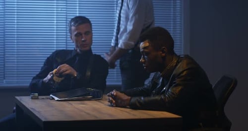 Police Interrogation of Suspect in Dark Room