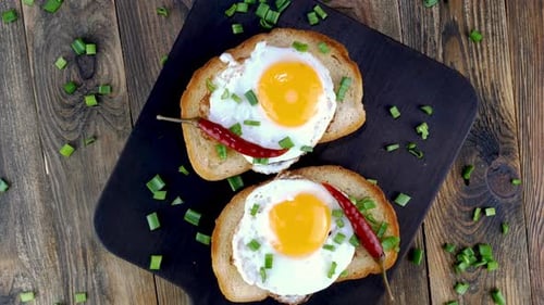 Fried Egg Sandwich with Yolk Chili Pepper on Toasted Slice of Bread Sprinkled with Green Onions