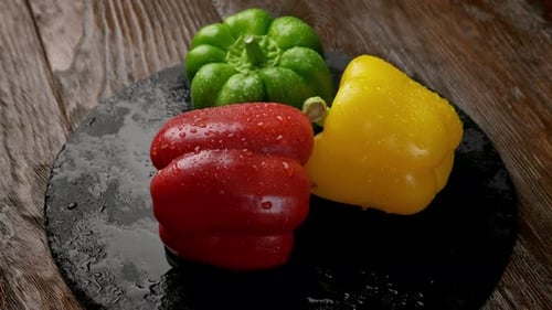 Colorful Bell Peppers with Water Droplets on Slate