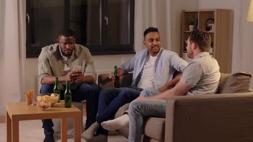 Friends Relaxing and Drinking Beers in Living Room