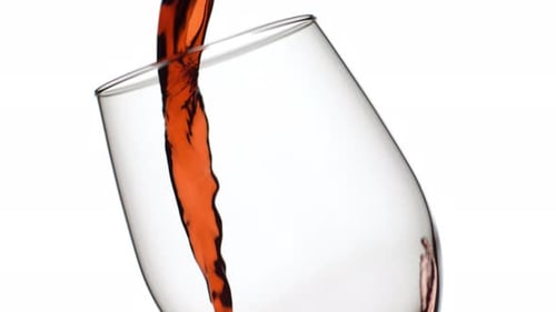 Red Wine Flowing Into Glass in a Close Up