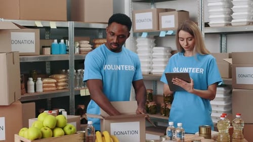 Volunteers Pack Donations in Charity Warehouse