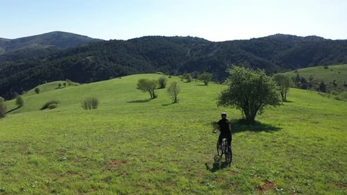Aerial View Of The Cyclist Ride A Bike In The Green Mountains 4