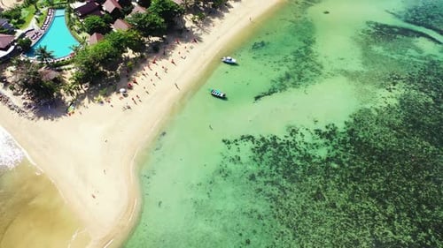 Aerial top down scenery of exotic resort beach lifestyle by blue sea and white sandy background of a