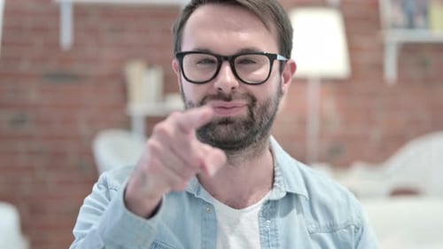 Man Points Finger Directly at the Camera