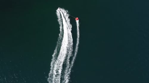 Jet Ski Pulling Tube Across Water, Aerial View