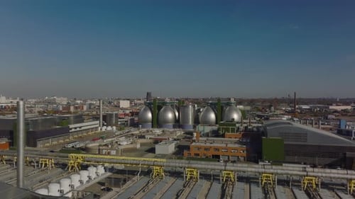 Forwards Fly Above Industrial Facility in Town Outskirts