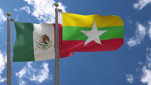 Flags of Mexico and Myanmar Waving Together Against Blue Sky