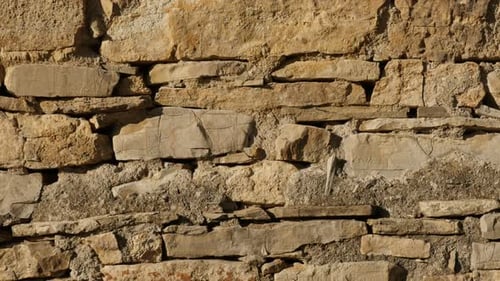 Stone wall layers slow tilt 4K 2160p 30fps UltraHD footage - Close-up of ancient masonry constructio