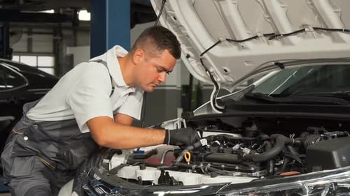 Cheerful Mechanic Enjoying Working at the Garage