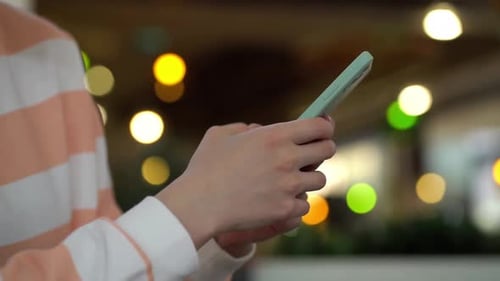 Hands Using Cell Phone at Night Close Up