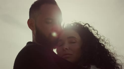 Romantic Couple Embracing in Golden Sunlight