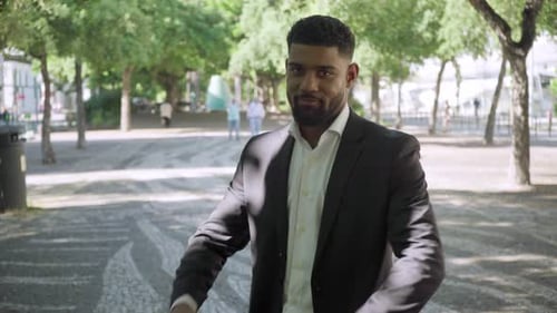Confident Man in Business Suit Smiles Outdoors