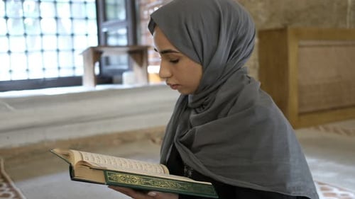 Young Hijab Woman Reading Quran