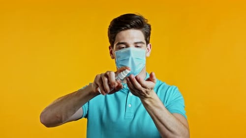 Man in Protective Mask Applies Disinfectant Antiseptic To His Hands and Then Shows - It Is Clean and
