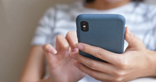 Woman Using Mobile Phone in a Close-up Shot