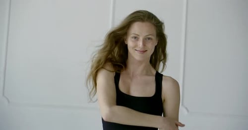 Sexy Cheerful Woman Is Posing for Camera in Studio in Daytime, Medium Shot