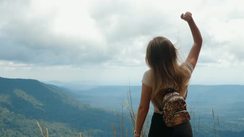 Female Tourist with Backpack Raising Hand Up Making Winner Gesture