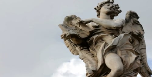 Stone Angel Sculpture Stands Against Cloudy Sky