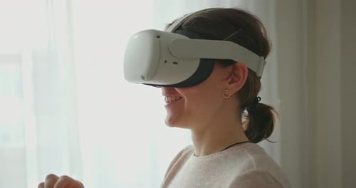 Woman Using Virtual Reality Headset at Home