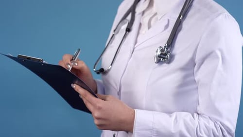 Unrecognizable Doctor Writing on Clipboard