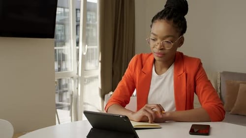 Woman in Orange Blazer Attends Video Conference