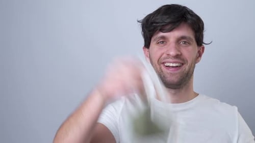 Close-up Portrait of a Man Removes a Respiratory Face Mask During the Quarantine of the COVID-19