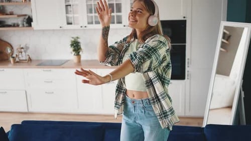 Woman Dancing to Music in her Kitchen