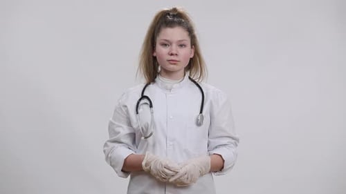 Child Doctor Gives Thumbs Up in White Lab Coat