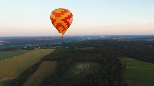 Hot Air Balloon in the Sky Over a Field.