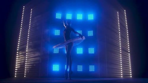 Graceful Ballerina Performing Ballet in Studio with Lights