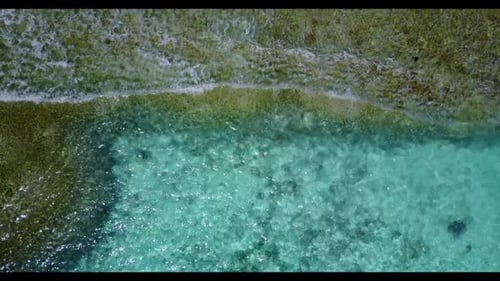 Aerial flying over nature of tropical shore beach voyage by blue green water with clean sandy backgr