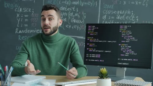Man Teaching Coding at Desk in Workplace