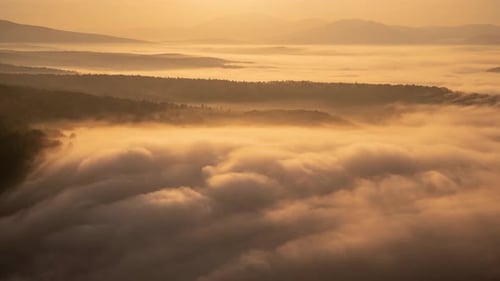 Golden Sunrise Light Over Misty Mountain Landscape