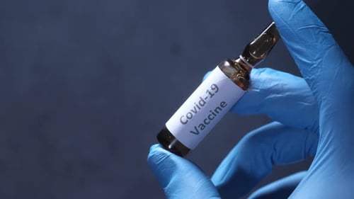 Hand in Gloves Holding Coronavirus, Vaccine, Close Up